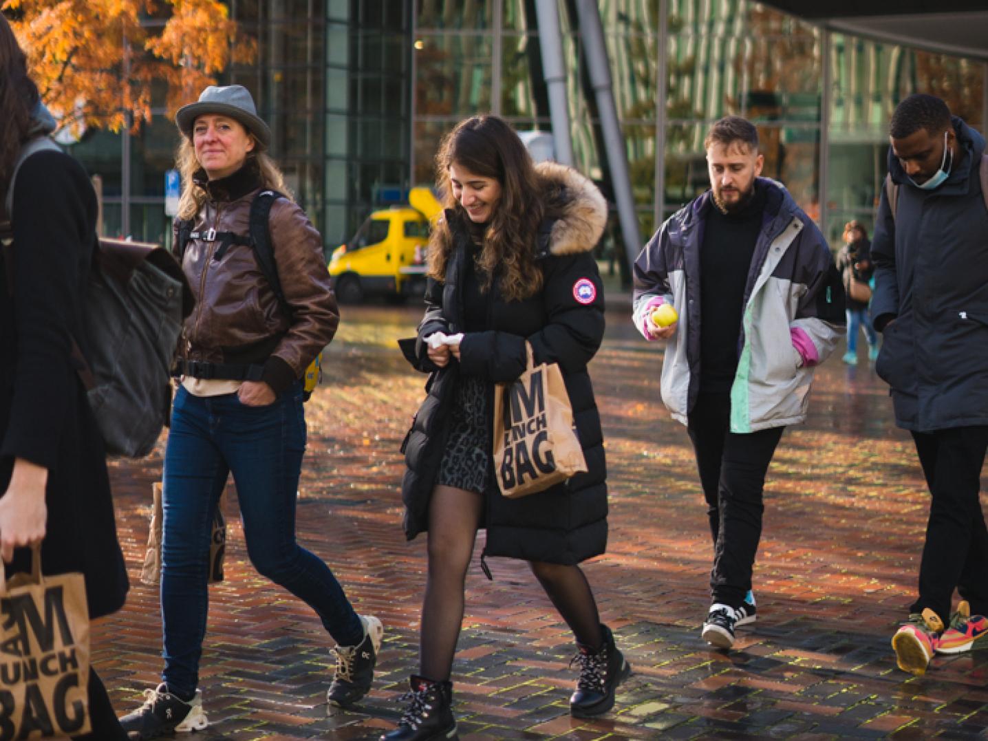 Irem Alpay, Niko Barrena and Kévi Donat walking through Amsterdam Zuidoost.