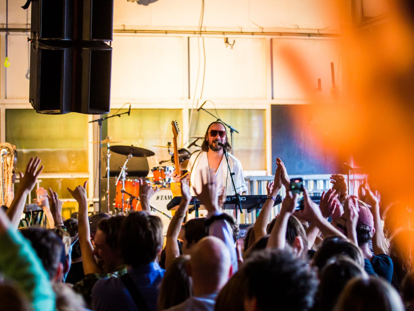 Man singing in front of crowd