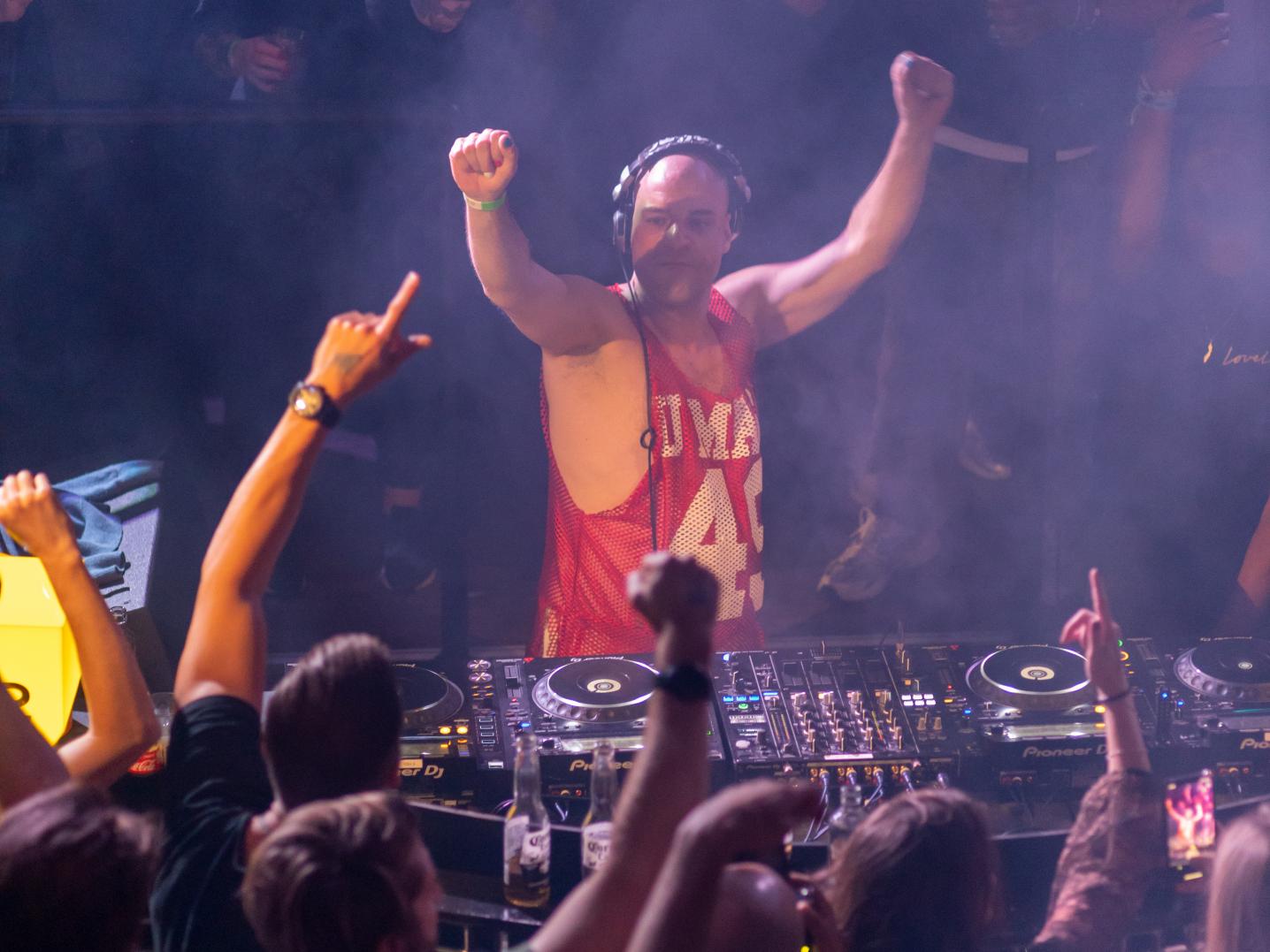 DJ surrounded by dancing people