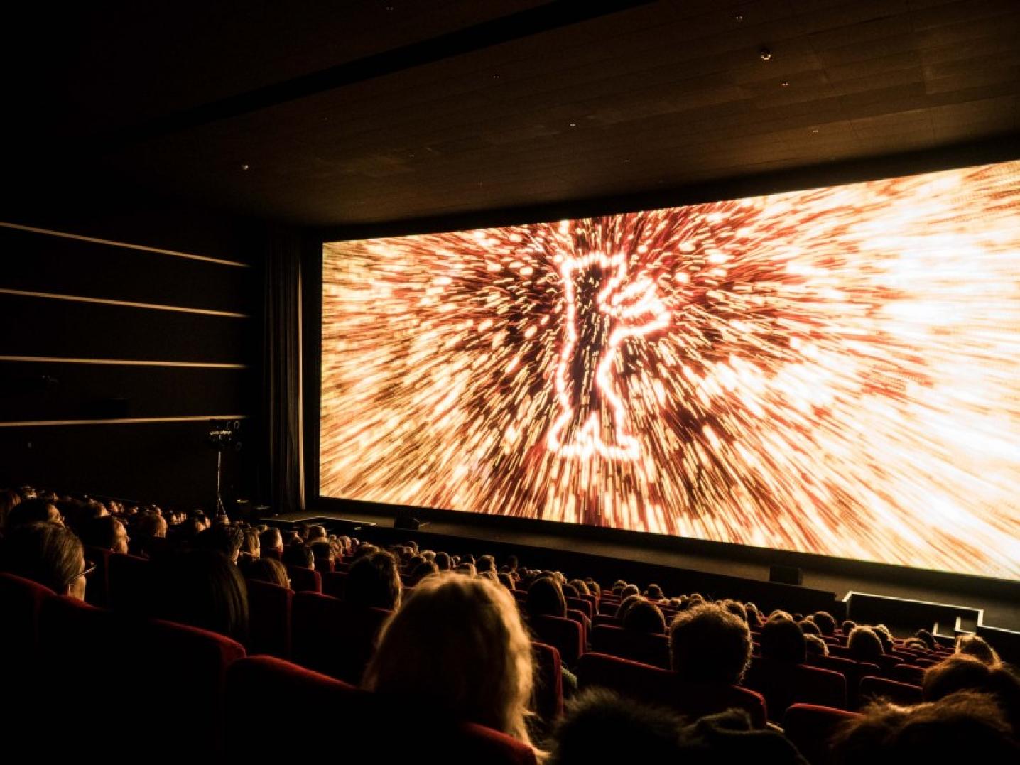 Berlinale logo on cinema screen with audience sitting in front