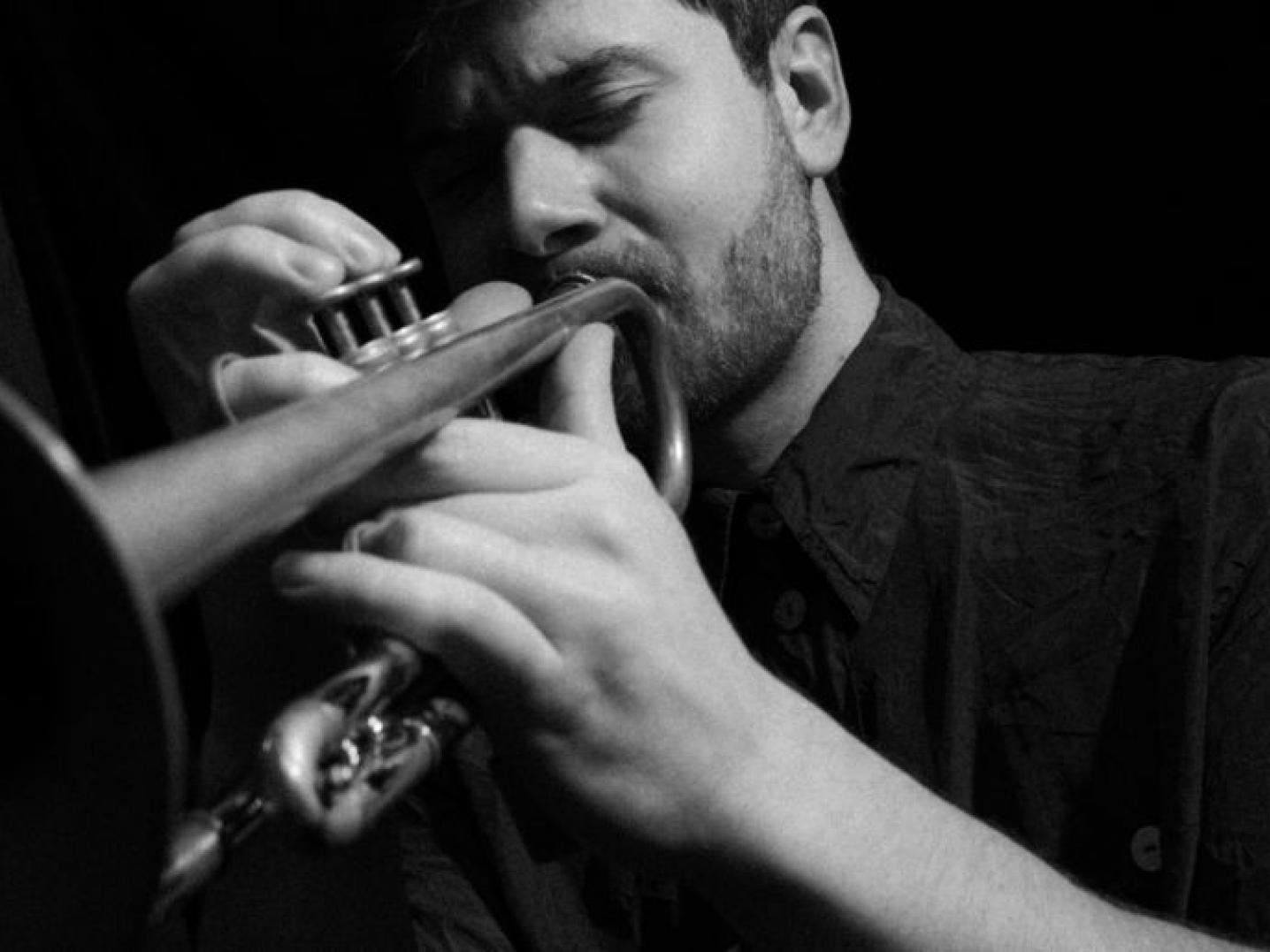 Black and white photo of man playing the trumpet