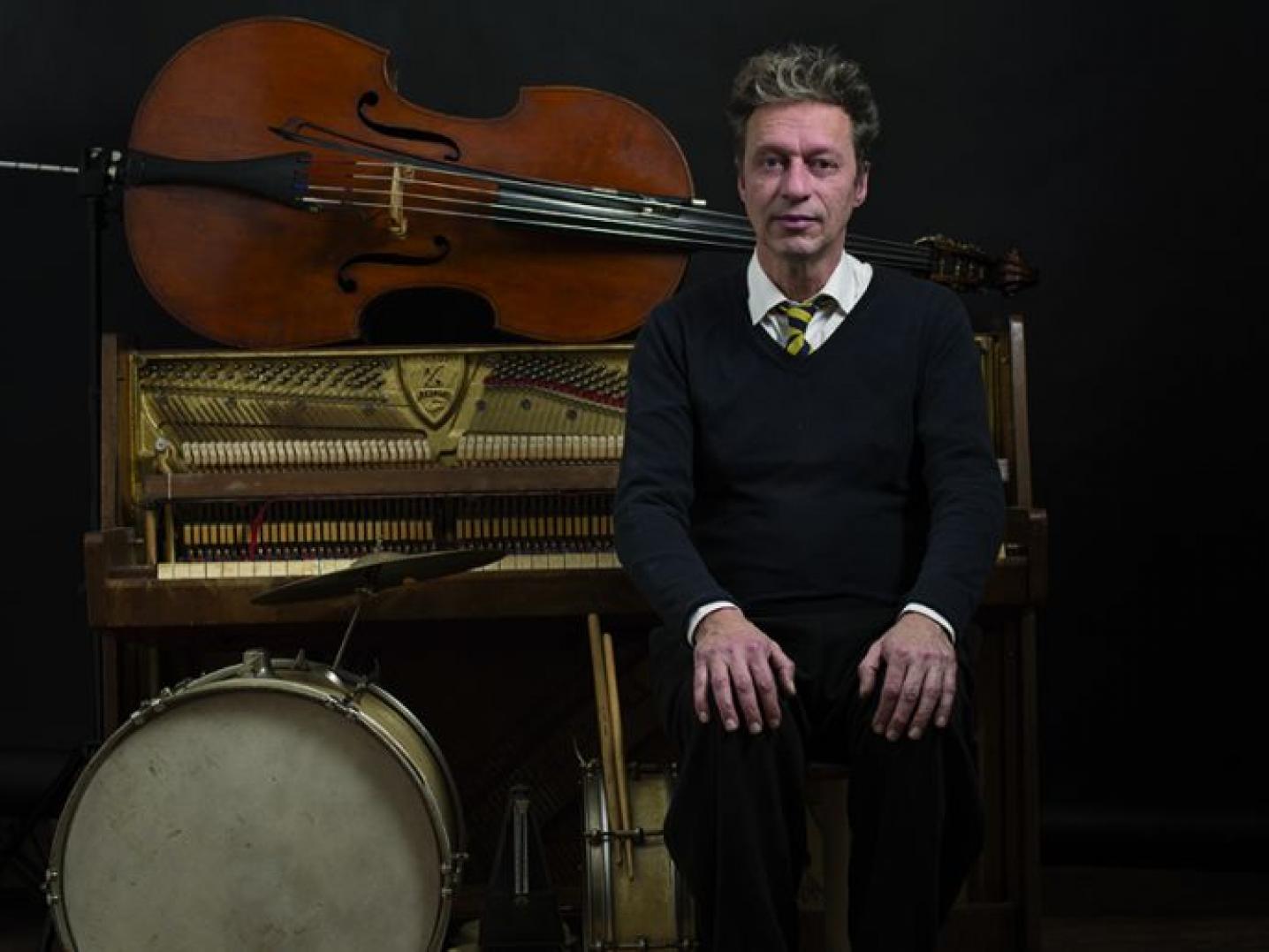 Man sitting in front of musical instruments