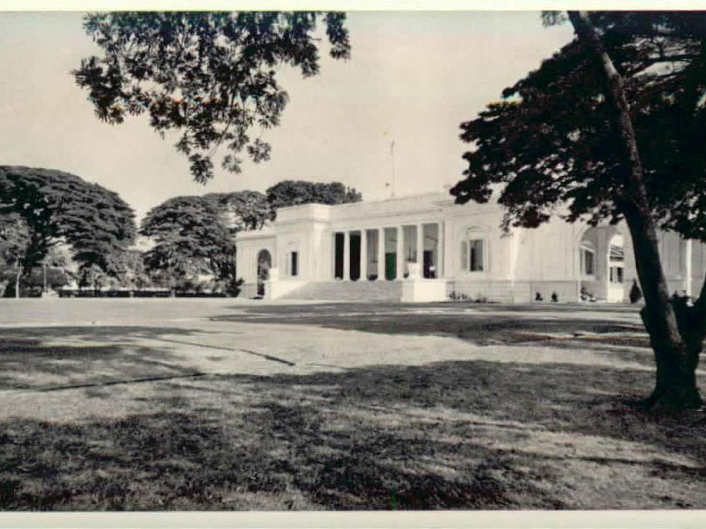 a large white palace in a park in the 1950s