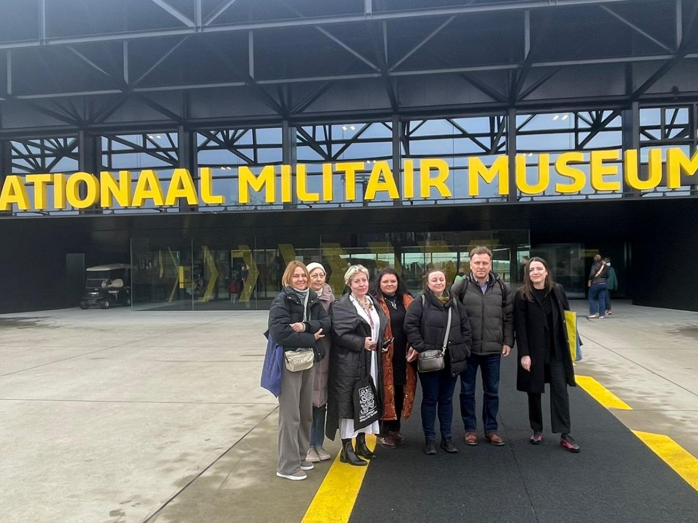 A group of people standing in front of a building saying Nationaal Militair Museum in the Netherlands