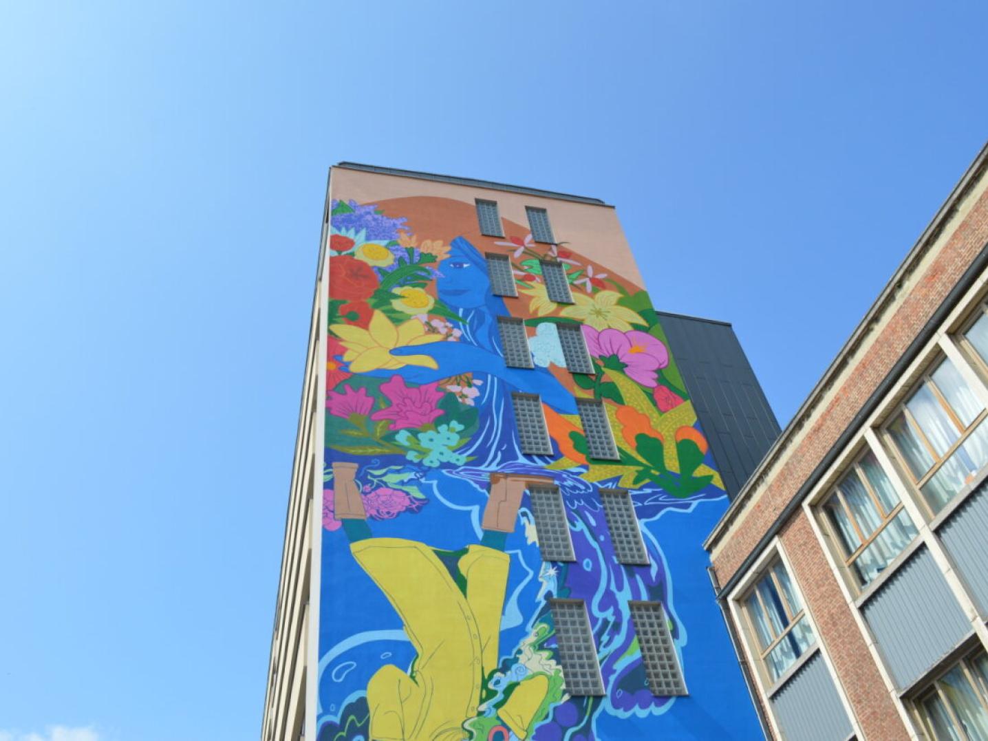 School building with a colourful mural painting called Rain Flowers