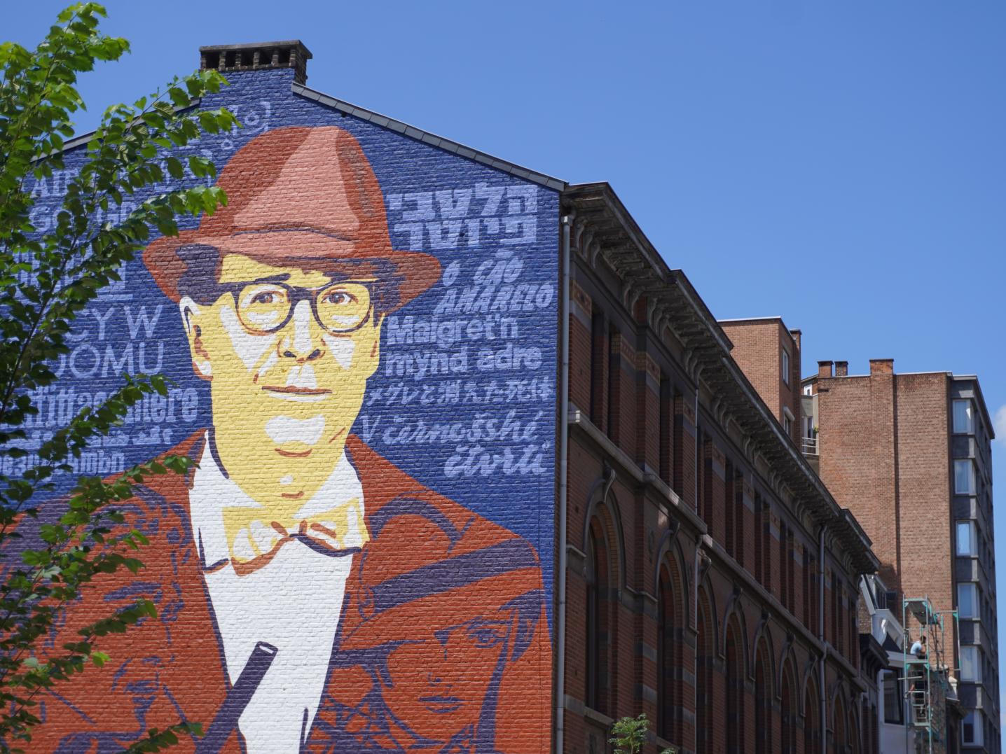 House front with a huge art mural depicting a famous Belgian writer.