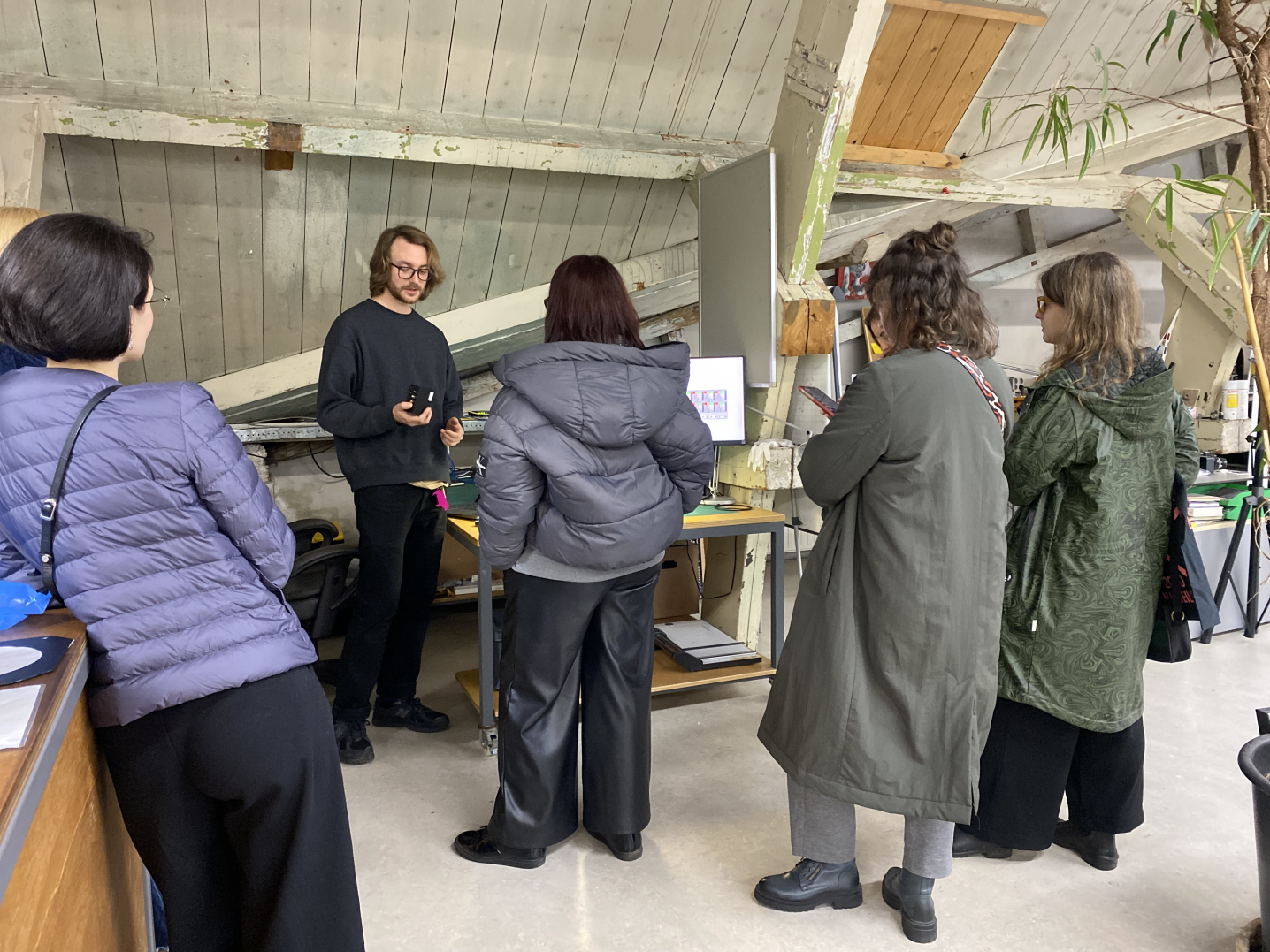 Visitors Programme participants from Ukraine are listening to an arts professional in an atelier