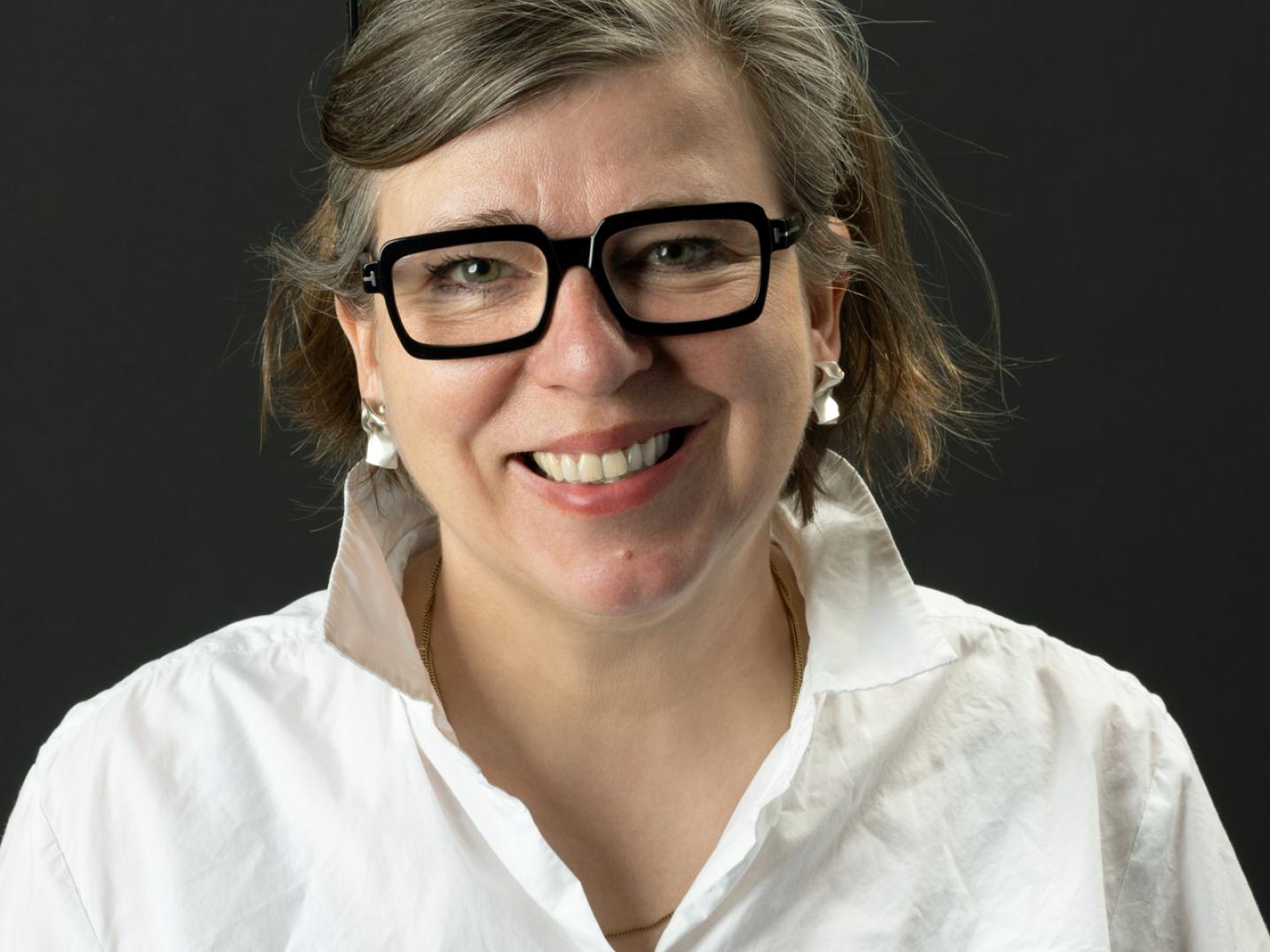 Woman with glasses and white blouse