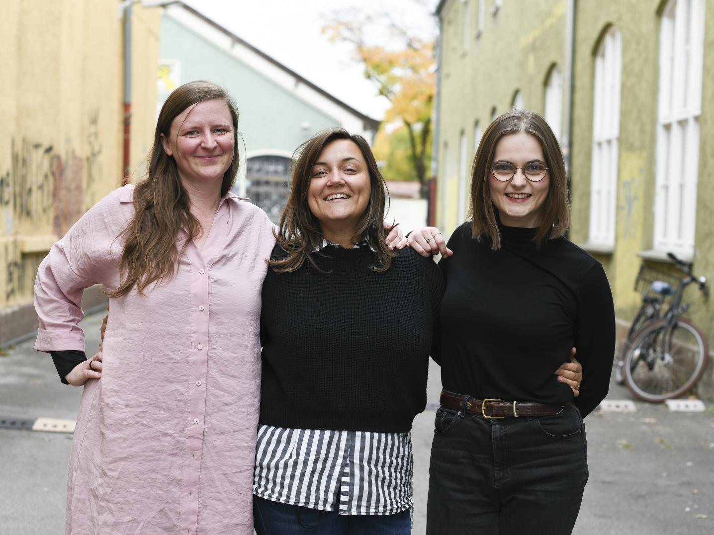 Three women standing on the street