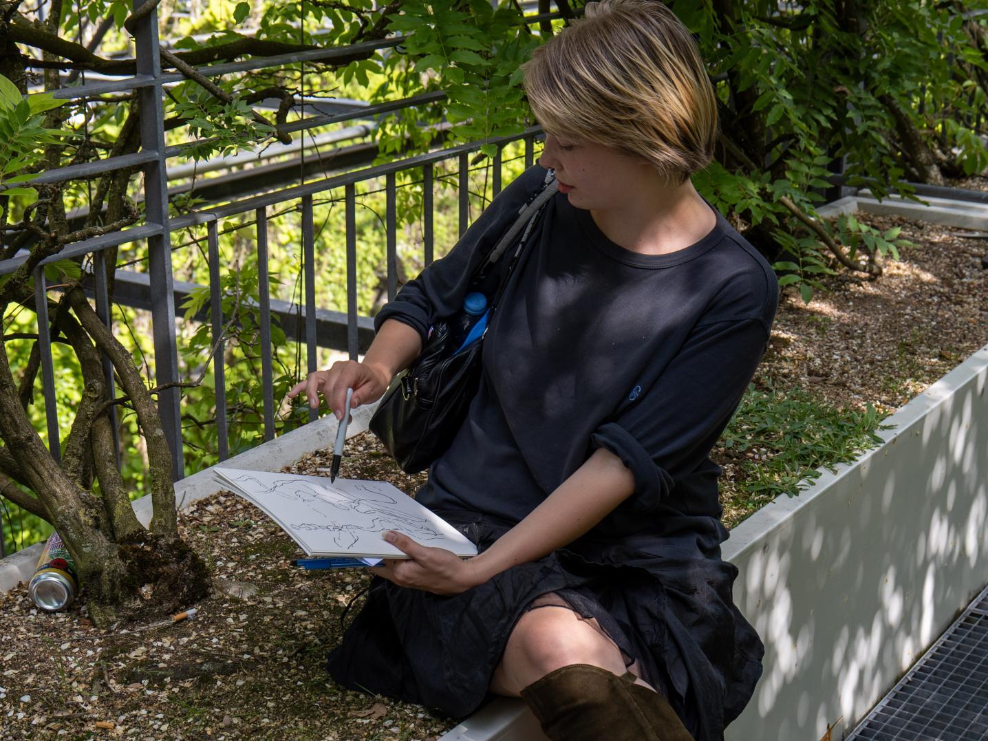 girl in black clothes with sketchpad 