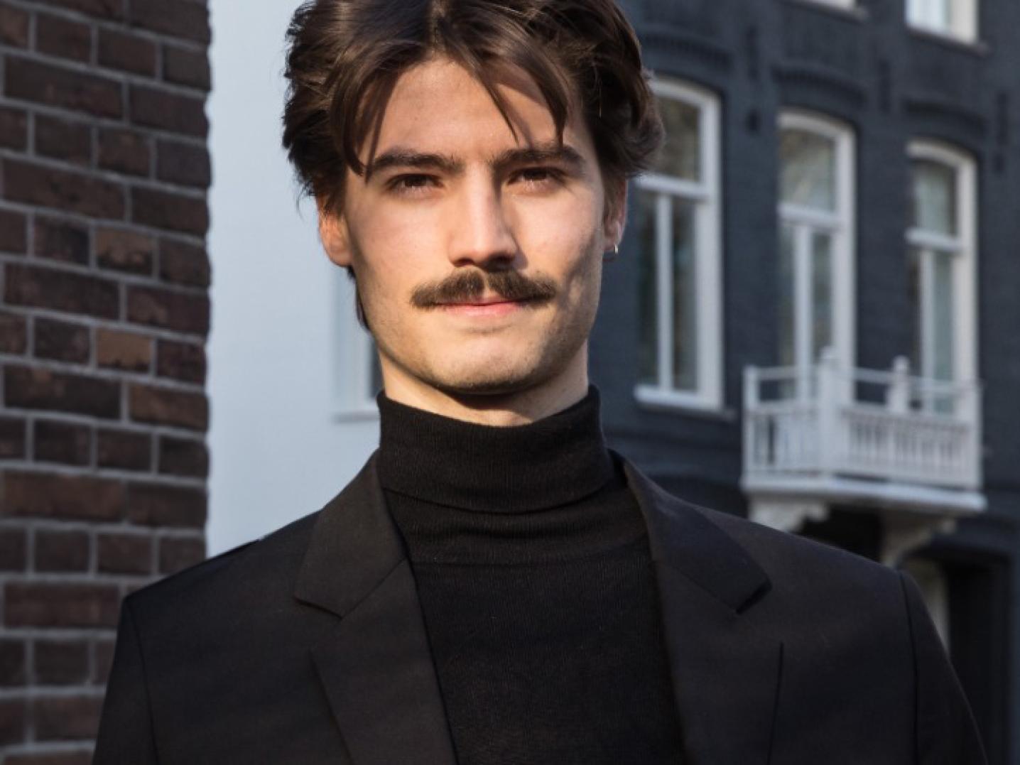 Photo of a sharply Portuguese man with a smart turtleneck and jacket