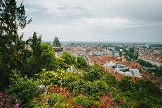 View from a mountain on a city with a tower in Graz, Austria.