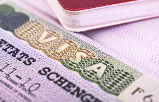 a pink paper slip with the words visa and etats schengen printed on it