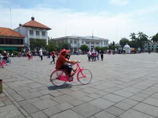 Man on bike at Fatahillah Square in front of former Batavia City Hall. Photo Remco Vermeulen
