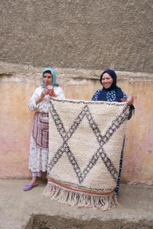 Cooperative Founder and project participants show a carpet