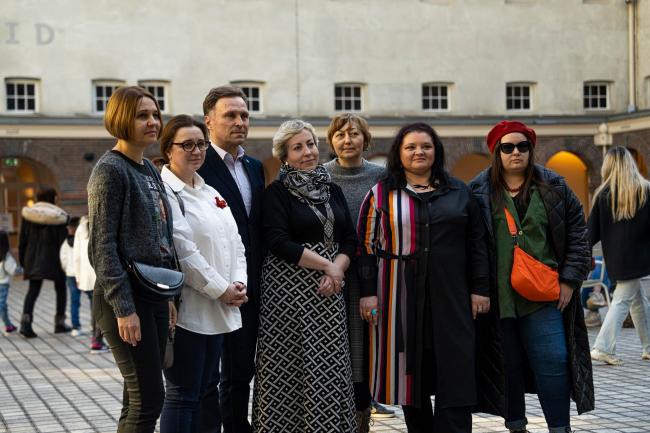 seven people grouped together in the court yard of the Maritime Museum Amsterdam