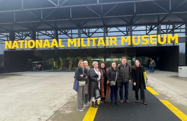 A group of people standing in front of a building saying Nationaal Militair Museum in the Netherlands