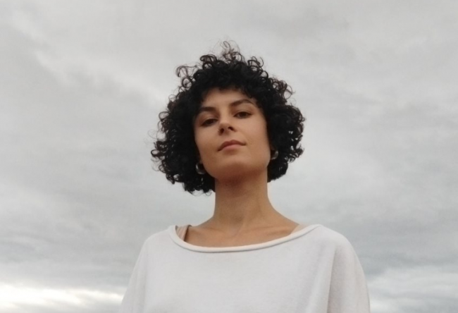 Hanna Rita Szabó in front of a white cloudy sky