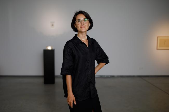 a woman standing in a museum room
