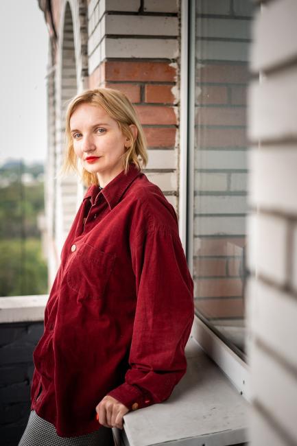 a woman sitting in a window sill