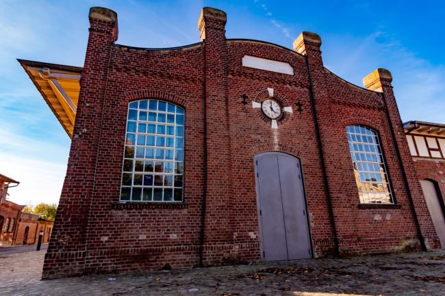 a large brick monumental building with a blue sky