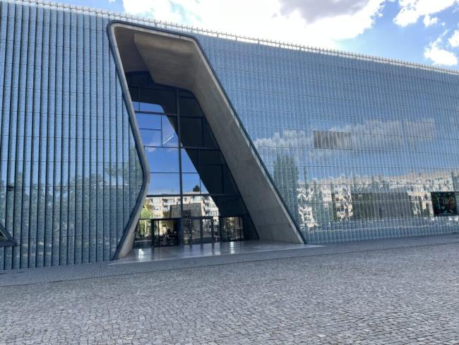 Large glass building with design entrance