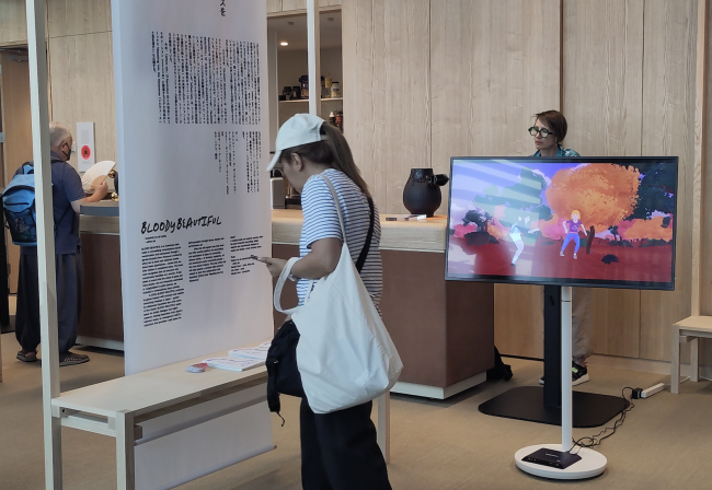 exhibition banner and video work in an exhibition space