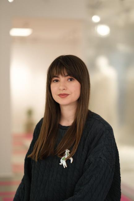 Portrait picture of a woman with dark brown hair and bangs