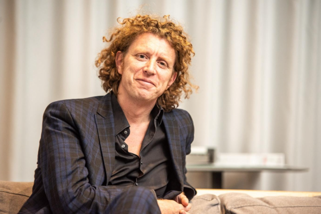Portrait picture of a man with curly ginger hair