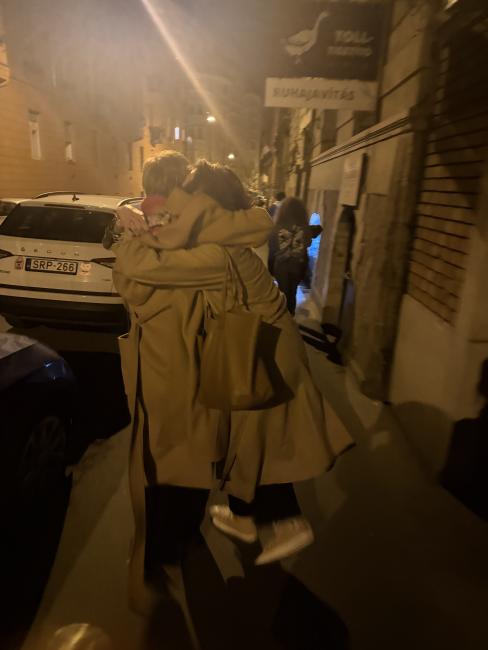 Two people hugging on the street