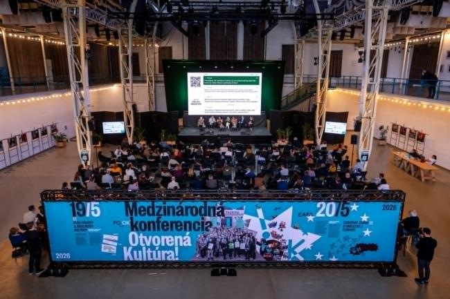Audience attending a conference in a large exhibition hall