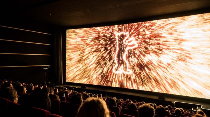 Berlinale logo on cinema screen with audience sitting in front