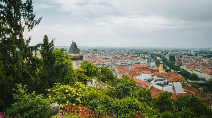 View from a mountain on a city with a tower in Graz, Austria.