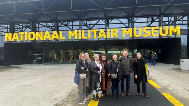 A group of people standing in front of a building saying Nationaal Militair Museum in the Netherlands