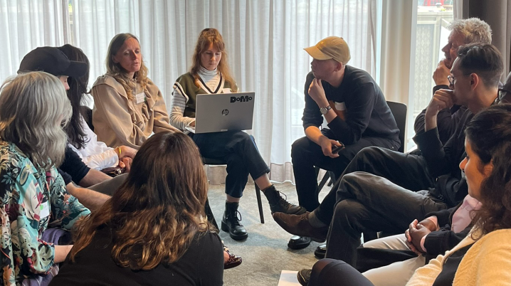 A round table discussion taking place in Amsterdam with cultural professionals sitting in a circle with a moderator